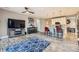 Open concept living space with hardwood floors, a ceiling fan, and an island at 10555 Boston St, Commerce City, CO 80640