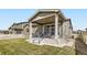 Cozy patio with outdoor seating, sliding glass door access, and a well-manicured lawn for relaxation at 10555 Boston St, Commerce City, CO 80640