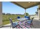 Covered patio with outdoor seating offering serene views of the surrounding landscape and neighborhood at 10555 Boston St, Commerce City, CO 80640