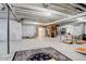 Unfinished basement with exposed ceiling, utility access, carpet, and large area for storage or recreation at 1265 Black Haw St, Elizabeth, CO 80107