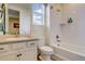 Clean bathroom featuring a sink, toilet, and bathtub/shower combination with tiled walls at 1265 Black Haw St, Elizabeth, CO 80107