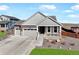 Beautiful home featuring a covered front porch and a three-car garage, complete with a well-manicured lawn at 1265 Black Haw St, Elizabeth, CO 80107