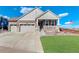 Charming two-story home with a well-manicured lawn, a two-car garage, and a welcoming front porch at 1265 Black Haw St, Elizabeth, CO 80107