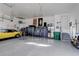 Spacious garage with epoxy flooring, cabinets, and plenty of room for cars and storage at 1265 Black Haw St, Elizabeth, CO 80107