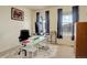 Home office with a modern desk setup, chair, and natural light from the two windows at 1265 Black Haw St, Elizabeth, CO 80107