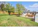 A large grass backyard features mature trees, a shed, and a wooden deck at 11172 W Exposition Dr, Denver, CO 80226