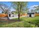 The backyard features mature trees, landscaping, a shed and concrete patio at 11172 W Exposition Dr, Denver, CO 80226