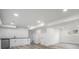 Finished basement with a wet bar, white cabinets, and laminate flooring at 11172 W Exposition Dr, Denver, CO 80226