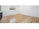 Bright bedroom featuring light hardwood floors, a window view, and modern baseboard trim at 11172 W Exposition Dr, Denver, CO 80226