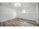 Bright bedroom featuring laminate flooring, a window, and neutral wall paint at 11172 W Exposition Dr, Denver, CO 80226
