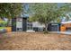 Charming split-level home showcasing a black and white exterior, attached garage, and front yard at 11172 W Exposition Dr, Denver, CO 80226