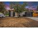 Charming split-level home showcasing a black and white exterior, attached garage, and front yard at 11172 W Exposition Dr, Denver, CO 80226