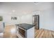 Spacious kitchen with a central island, stainless steel appliances, and hardwood flooring at 11172 W Exposition Dr, Denver, CO 80226