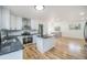 Modern kitchen with white cabinets, dark countertops, stainless steel appliances, and hardwood floors at 11172 W Exposition Dr, Denver, CO 80226