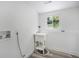 Bright laundry room features a utility sink and modern vinyl plank flooring at 11172 W Exposition Dr, Denver, CO 80226