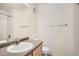 Bright bathroom features a shower/tub, toilet and sink vanity with ample lighting at 12711 Colorado Blvd # 607F, Thornton, CO 80241