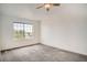 Bright bedroom featuring a ceiling fan, neutral paint, and a large window at 12711 Colorado Blvd # 607F, Thornton, CO 80241