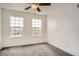 Well-lit bedroom featuring a ceiling fan, neutral paint, and two windows at 12711 Colorado Blvd # 607F, Thornton, CO 80241