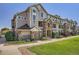 Well-maintained condo building with stone accents, manicured lawn, and inviting walkways at 12711 Colorado Blvd # 607F, Thornton, CO 80241