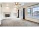 Living room features a fireplace, large windows, balcony access, and lots of light at 12711 Colorado Blvd # 607F, Thornton, CO 80241