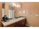 Bathroom with decorative mirror and vanity, featuring ample counter space and storage at 2662 S Cathay Way # 112, Aurora, CO 80013