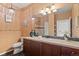 Bathroom with decorative mirror and vanity, featuring ample counter space and storage at 2662 S Cathay Way # 112, Aurora, CO 80013