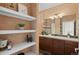 Bathroom featuring a vanity with decor, floating shelves, and a shower-tub combination with glass door at 2662 S Cathay Way # 112, Aurora, CO 80013