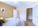 Comfortable bedroom featuring plush carpet, neutral tones, and walk-in closet with ample storage for clothes and accessories at 2662 S Cathay Way # 112, Aurora, CO 80013