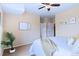 Spacious bedroom featuring soft lighting, plush carpet, and ample closet space for storage solutions at 2662 S Cathay Way # 112, Aurora, CO 80013