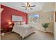 Bright bedroom featuring a ceiling fan, large window, and a comfortable bed with stylish accents at 2662 S Cathay Way # 112, Aurora, CO 80013