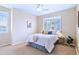 Bright bedroom featuring neutral tones, comfortable bedding, and a window for natural light and ventilation at 2662 S Cathay Way # 112, Aurora, CO 80013