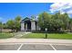 Inviting community clubhouse with lush green lawn and manicured landscaping at 2662 S Cathay Way # 112, Aurora, CO 80013