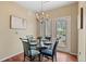 Dining area featuring hardwood floors, neutral paint and a modern chandelier at 2662 S Cathay Way # 112, Aurora, CO 80013