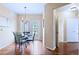 Bright dining room featuring hardwood floors, stylish lighting fixture, and convenient access to the outdoors at 2662 S Cathay Way # 112, Aurora, CO 80013