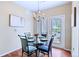 Cozy dining room with modern chandelier and glass-top table at 2662 S Cathay Way # 112, Aurora, CO 80013