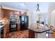 Well-equipped kitchen features dark cabinetry, stainless steel appliances, and counter seating at 2662 S Cathay Way # 112, Aurora, CO 80013
