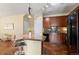 Cozy kitchen featuring dark cabinets, tile countertops and bar stool seating at 2662 S Cathay Way # 112, Aurora, CO 80013