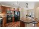 Modern kitchen with stainless steel appliances, wood cabinets, and an island with seating for casual dining at 2662 S Cathay Way # 112, Aurora, CO 80013