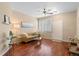 Cozy living area with wood floors, a ceiling fan, and a comfortable sofa illuminated by a bright window at 2662 S Cathay Way # 112, Aurora, CO 80013