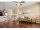 Inviting living room featuring rich wood floors, a ceiling fan, and a comfortable seating area with natural light at 2662 S Cathay Way # 112, Aurora, CO 80013
