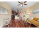 Open living area with wood floors, neutral paint and access to kitchen and dining area at 2662 S Cathay Way # 112, Aurora, CO 80013