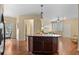 Open concept living area with hardwood floors, an island and neutral paint at 2662 S Cathay Way # 112, Aurora, CO 80013
