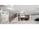 Finished basement with carpet, staircase, and ample space for a second living area or recreation room at 156 Chapel Hill Cir, Brighton, CO 80601