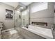 Modern bathroom featuring a soaking tub, walk-in shower, and contemporary tile work at 156 Chapel Hill Cir, Brighton, CO 80601