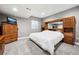 Basement bedroom with neutral carpet, oak closet and dresser; recessed lighting, and a flat panel TV at 156 Chapel Hill Cir, Brighton, CO 80601