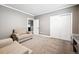 Bright room with two beige sofas, gray walls and carpet, and a closet at 156 Chapel Hill Cir, Brighton, CO 80601