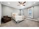Bright bedroom featuring a ceiling fan, natural light, and a cozy chair at 156 Chapel Hill Cir, Brighton, CO 80601