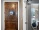 View of entryway featuring front door with peep window and view to dining area at 156 Chapel Hill Cir, Brighton, CO 80601