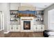 Stone fireplace is flanked by floating shelves and cabinets, creating a striking focal point at 156 Chapel Hill Cir, Brighton, CO 80601