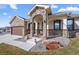 Charming home featuring a stone archway entry, beautiful stone accents and a professionally landscaped yard at 156 Chapel Hill Cir, Brighton, CO 80601